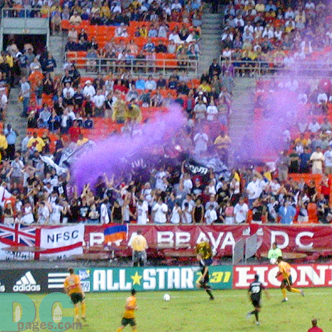 The fans love the goal and celebrate with purple smoke.