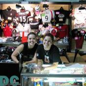 Michelle and Candice are all smiles while selling DC United accessories.