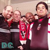 DC United fans standing in proud support of their team.