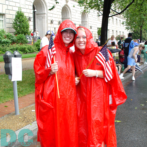These two ladies pose with their American flags as they wait for the parade to get underway.