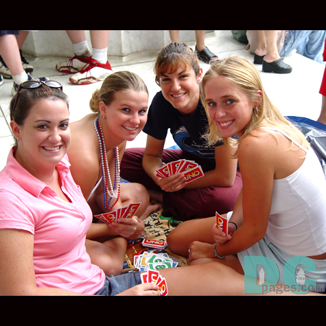 These girls are playing Uno.  They are taking this time to relax before the fireworks start.