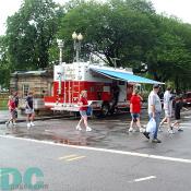 People cross the street in front of a DC Fire Truck.