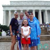 This family poses in front of the Lincoln Memorial .  They went all out with matching patriotic dyed hair.
