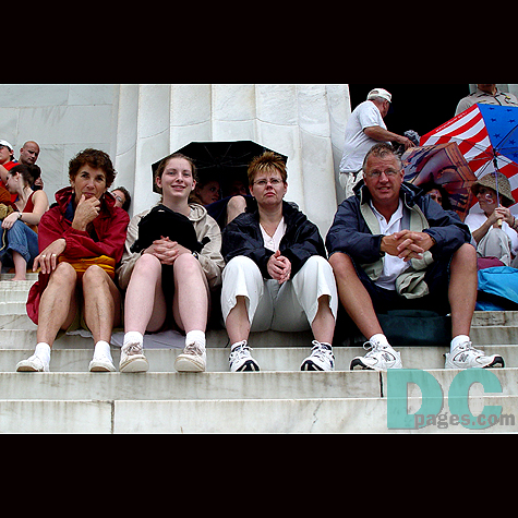 This family is taking a welcomed break on the steps of the Lincoln Memorial.