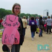 Pro-Choice activist holding demonstration sign - (design of pink slip dress) PINK SLIP BUSH -
