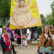 Two activists hold a female diety sign - ITS OURS TO MAKE -
