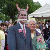One gentleman marching on April 25th expressed his feelings about President Bush by using a cardboard cut-out photograph of the President with devil-like horns added and tape across the mouth.