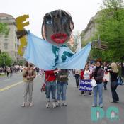 Four marchers hold large puppet of a person holding a key.  In the background a marcher holding a sign PRO-FAMILY, PRO-CHOICE.