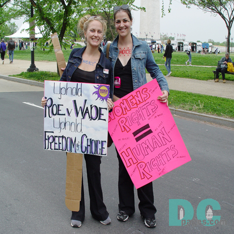 Two women painted CHOICE on their bodies and hold signs: UPHOLD ROE V. WADE, UPHOLD FREEDOM OF CHOICE and WOMEMS RIGHTS = HUMAN RIGHTS.