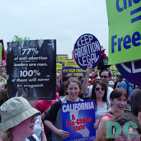77 PERCENT OF ANTI-ABORTION LEADERS ARE MEN. 100 PERCENT OF THEM WILL NEVER BE PREGNANT.  A marcher from California holds a sign proclaiming she lives in a Pro-Choice state while another exclaims to KEEP ABORTION LEGAL.
