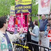 Planned Parenthood marchers direct their signs, STOP THE WAR ON CHOICE!, to the Pro-Life advocates that lined the march route.