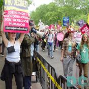 Pro-Life advocates used bullhorns to express their views to marchers.  On pro-choice marcher crossed the barracade holding her Planned Parenthood sign.