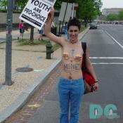 This woman declares her body her own by writing MINE across her stomach.  She carries a YOUTH ARE PRO-CHOICE sign.