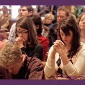 Young Catholic adults in prayer.