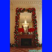 Fireplace located in the East Room is adorned with large red and silver christmas balls.