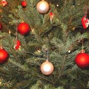 A close up of the ornaments displayed on of the Christmas trees