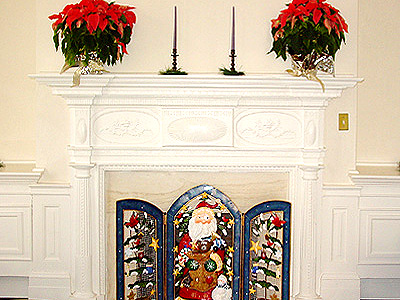 The gorgeous fireplace covered in Christmas decorations