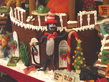 Dr. Suess' The Cat and the Hat plays in the yard of the gingerbread house.