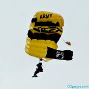 Golden Knights parachutist displaying POW-MIA flag during descent