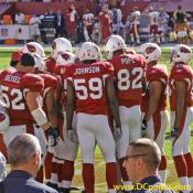 Cardinals Special Teams huddle up and listen to their coach's play.
