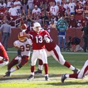 Andre Carter comes close to stripping the ball from Kurt Warner (13).