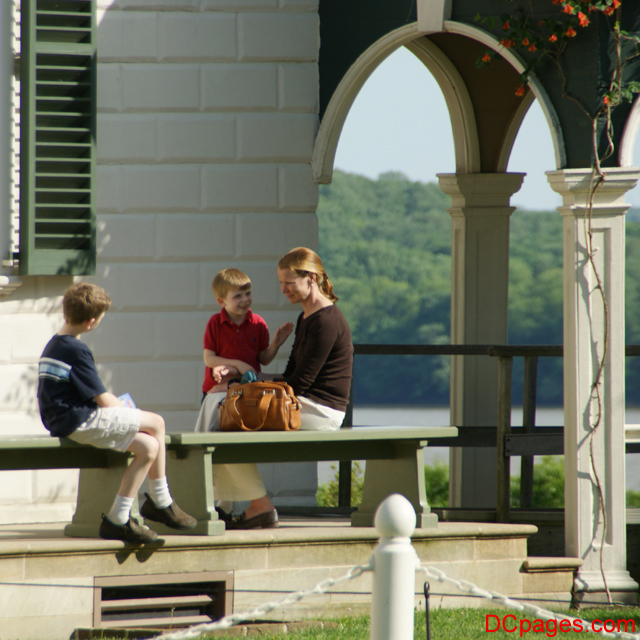 A mother sits with her two boys overlooking the Potomac River - Mount Vernon Estate