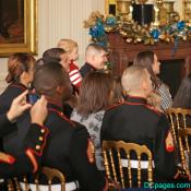 U.S. Marines and family members listen to Michelle Obama
