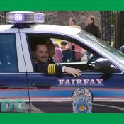 Fairfax Chief of Police smiles to the St Patricks Day parade crowd.