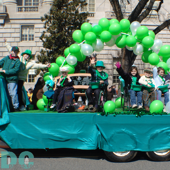 St Patricks day parade float - Green balloons, green clothes, and big festive Irish smiles from this group throwing candy to the kids.