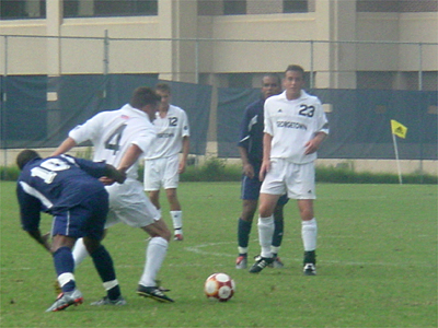David Eder, #4, gets the ball past a Howard player, while teammate Daniel Grasso watches on.