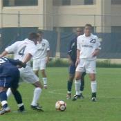 David Eder, #4, gets the ball past a Howard player, while teammate Daniel Grasso watches on.