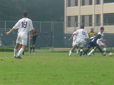 Forward Paul Brandley looks on as Howard steals the ball from two Georgetown Hoyas.