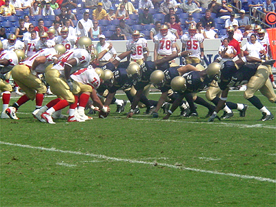 The Navy's offensive line get ready to bring the ball down the field while the Keydets try to stop them.
