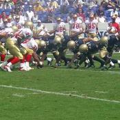 The Navy's offensive line get ready to bring the ball down the field while the Keydets try to stop them.