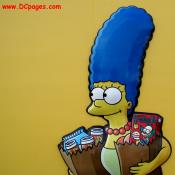 Closup of Marge carrying a bag of KrustyO's and Buzz Cola.