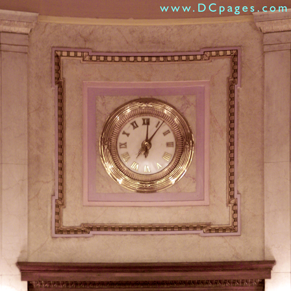 Gold clock mounted on faux plaster. The craftsmen really made it look like marble.