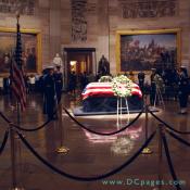 The Lying of State, President Gerald Ford, United States Capitol Rotunda. An American flag is draped over the casket. Two wreaths are displayed with the words 'House of Representatives' (shown) and 'United States Senate.'