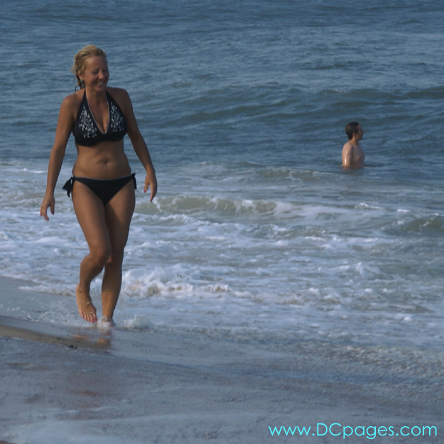 Ocean City - This woman takes a leisurely stroll down the beach at Ocean City.