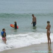 Ocean City - This family is enjoying their day at the beach. The father is teaching the youngest how to boogie board.