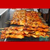 Rows of skewered barbecued chicken.