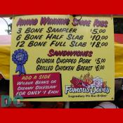Famous Daves sign displaying award winning ribs and sandwich prices.