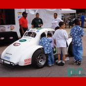 Kids looking in race car.