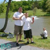This young man and father proudly displays a fresh caught blue gill. His brother (right) looks mighty happy to be just enjoying the day with his family.