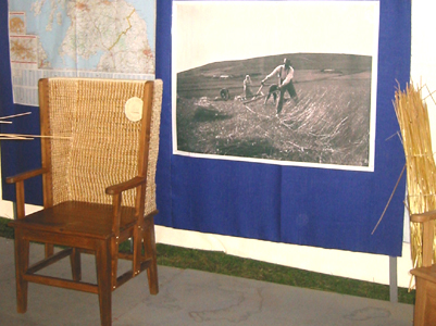 A Orkney chair with pictures of the olden days in the background