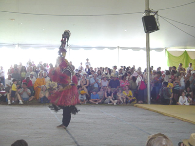 Dogon Masked dancer entertains the packed tent