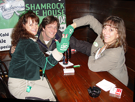 These Saint Patty's veterans proudly display their 'Rolling Rock' drinking gloves. Doug hams it up in the background.
