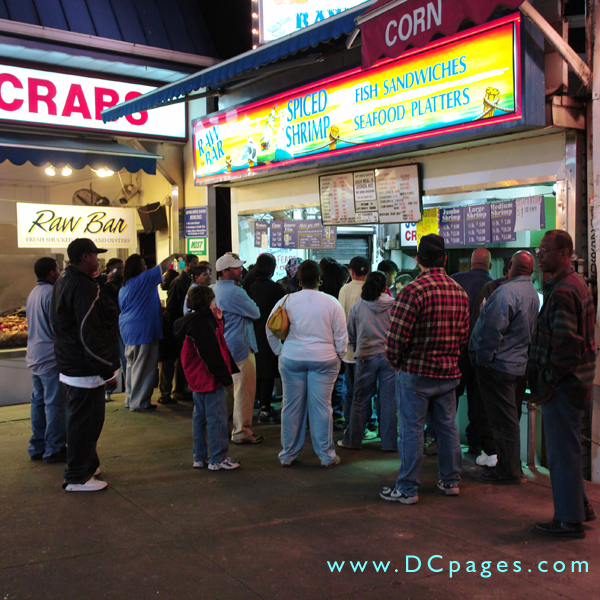 A line forms at Captain Whites to-go shop, waiting to get some darn tasty seafood platters.