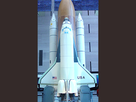 A really large scale model of the Space Shuttle in it's launch position.