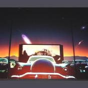 An interesting image of a drive in movie theatre with the heavens above