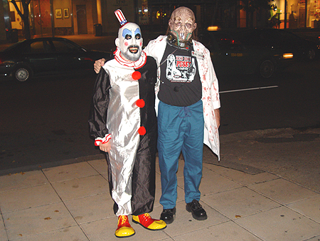 Oh #!?@ it's Captain Spaulding the store keeper, and Dr. Satan from the movie The House of a 1000 Corpses, a Rob Zombie movie. HAPPY HALLOWEEN.